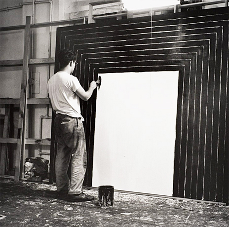 Frank Stella dans son atelier réalisant l'une de ses peintures noires, 1958-1962.